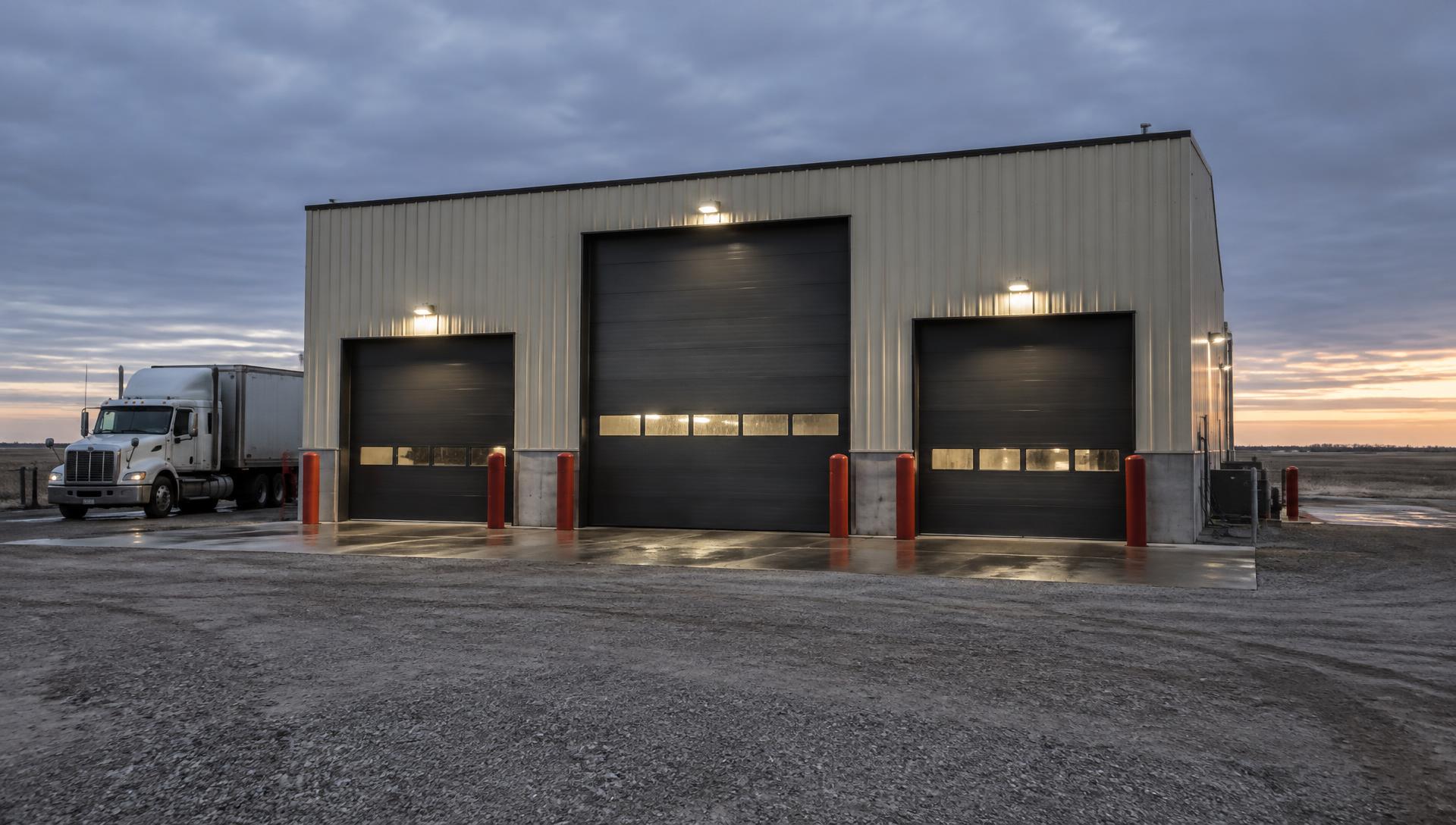 Big T's Truck Wash facility with three overhead wash bay doors